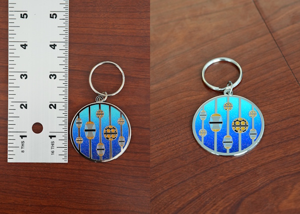Two-inch enamel 'Upgrade' keychain